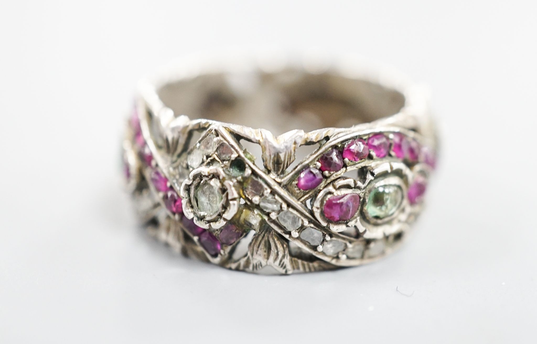 A 19th century Austro-Hungarian pierced white metal, diamond and gem set band, size W/X.